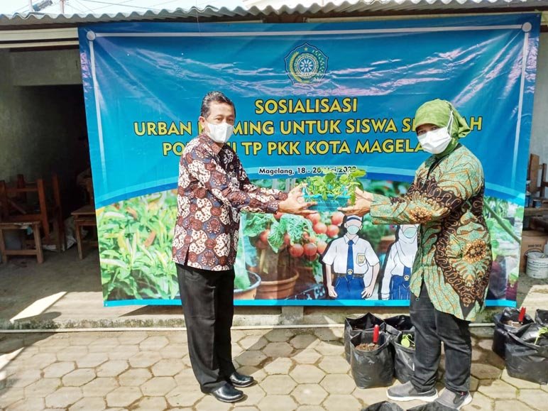 PENYERAHAN BIBIT. Ketua Pokja 3, Retno Rini memberikan bibit kepada SMPN 3 Magelang diterima Kepala Sekolah Nurwiyono.(Foto heni)